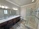 Modern bathroom features a glass shower, double vanity, and tile flooring for a sleek and functional design at 210 Magnolia Blvd, Pahrump, NV 89048