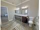 Modern bathroom with a tiled shower, double vanity, and toilet for a sleek and functional design at 210 Magnolia Blvd, Pahrump, NV 89048
