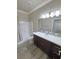 Bathroom featuring a sink, quartz countertops, cabinets, and tub with shower at 210 Magnolia Blvd, Pahrump, NV 89048