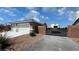 Home featuring a gated driveway, landscaping, and multi-car garage at 210 Magnolia Blvd, Pahrump, NV 89048