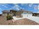 Charming single-story home featuring a desert-landscaped front yard and two-car garage at 210 Magnolia Blvd, Pahrump, NV 89048