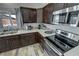 Updated kitchen featuring modern appliances, dark cabinetry, and sleek countertops at 210 Magnolia Blvd, Pahrump, NV 89048