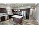 Spacious kitchen with dark wood cabinets, stainless steel appliances, and a center island at 210 Magnolia Blvd, Pahrump, NV 89048
