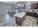 Well-appointed kitchen with stainless steel appliances, center island, and adjacent dining area at 210 Magnolia Blvd, Pahrump, NV 89048