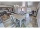 Open-concept living space with wood-look flooring, dining area, and modern kitchen at 210 Magnolia Blvd, Pahrump, NV 89048
