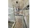 Tiled shower with a glass door, niche shelving, and grab bars for a convenient and accessible bathing experience at 210 Magnolia Blvd, Pahrump, NV 89048