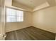 Bright bedroom with neutral walls, wood-look flooring, and large window for natural light at 23 E Agate Ave # 308, Las Vegas, NV 89123