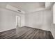 Bedroom with plank flooring, bright white walls and neutral accents at 23 E Agate Ave # 308, Las Vegas, NV 89123