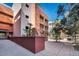 Inviting courtyard with stone pathway, mature trees and architectural building features at 23 E Agate Ave # 308, Las Vegas, NV 89123