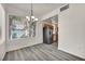 Bright dining area open to kitchen with stainless steel refrigerator and wood-look flooring at 23 E Agate Ave # 308, Las Vegas, NV 89123