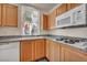 Cozy kitchen featuring a white dishwasher, granite countertops and light wood cabinetry near a window at 23 E Agate Ave # 308, Las Vegas, NV 89123