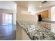Open kitchen with granite countertops and bar seating, stainless steel appliances and recessed lighting at 23 E Agate Ave # 308, Las Vegas, NV 89123