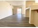 Open concept living area with sliding glass doors to balcony, wood-look floors and neutral paint at 23 E Agate Ave # 308, Las Vegas, NV 89123
