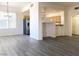 Bright living room featuring modern gray wood-look floors and an open floor plan to the kitchen at 23 E Agate Ave # 308, Las Vegas, NV 89123