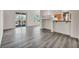 Well-lit living room with laminate flooring, kitchen view and balcony access at 23 E Agate Ave # 308, Las Vegas, NV 89123