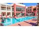 Beautiful community pool with ample seating for residents and a modern clubhouse visible behind at 23 E Agate Ave # 308, Las Vegas, NV 89123