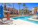 Resort-style swimming pool with lounge chairs and palm trees, provides a relaxing atmosphere at 23 E Agate Ave # 308, Las Vegas, NV 89123