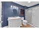 Modern bathroom featuring stylish vanity, an enclosed shower, and blue accent walls at 2825 Brianwood Ct, Las Vegas, NV 89134
