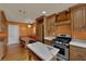 Warm kitchen features an island, marble countertops, wood cabinets, stainless steel appliances, and breakfast nook at 2825 Brianwood Ct, Las Vegas, NV 89134