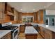Gourmet kitchen features custom cabinetry, stone countertops, stainless steel appliances, and an eat-in island at 2825 Brianwood Ct, Las Vegas, NV 89134
