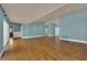 Bright, open living space featuring sleek hardwood floors, blue walls and multiple entryways to the rest of the home at 2825 Brianwood Ct, Las Vegas, NV 89134