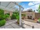 Inviting outdoor living space featuring a stone fireplace and covered patio with comfortable seating at 2825 Brianwood Ct, Las Vegas, NV 89134