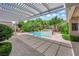 Beautiful backyard pool with lush landscaping, a spa, and a covered patio area at 2825 Brianwood Ct, Las Vegas, NV 89134