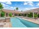 Beautiful backyard with pool, spa, patio cover, tile and outdoor living space at 2825 Brianwood Ct, Las Vegas, NV 89134