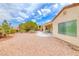 Low maintenance backyard with mature landscaping, gravel, and a covered patio area at 3050 Canal Walk Rd, Henderson, NV 89052