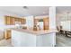 Well-lit kitchen with white appliances, wood cabinetry and adjacent dining area at 3050 Canal Walk Rd, Henderson, NV 89052