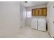 Practical laundry room includes a washing machine, a dryer, and cabinets for storage at 3050 Canal Walk Rd, Henderson, NV 89052
