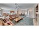 Spacious living room features a ceiling fan, fireplace, and open access to the kitchen and dining area at 3050 Canal Walk Rd, Henderson, NV 89052