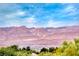 Scenic view of mountain range under a clear blue sky with the tops of trees in the foreground at 3050 Canal Walk Rd, Henderson, NV 89052