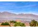 Stunning mountain views in the distance; beautiful palm trees and rooftop tile in the foreground at 3050 Canal Walk Rd, Henderson, NV 89052