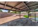 A backyard with a covered patio features a stone fire pit area and artificial turf, perfect for entertaining guests at 3086 Cardinal Dr, Las Vegas, NV 89121
