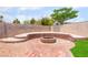 A backyard gathering space featuring a tiered brick fire pit area perfect for outdoor relaxation and entertainment at 3086 Cardinal Dr, Las Vegas, NV 89121