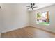 Inviting bedroom with wood-look floors, bright window, and modern ceiling fan at 3086 Cardinal Dr, Las Vegas, NV 89121