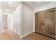 Hallway with light wood floors, white trim, and eye-catching wood doors at 3086 Cardinal Dr, Las Vegas, NV 89121
