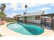 Private backyard oasis featuring pool, grass area, and covered patio at 3086 Cardinal Dr, Las Vegas, NV 89121