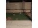This cozy backyard features a small grassy area with a cinderblock retaining wall at 3128 Spring City Ave, North Las Vegas, NV 89081