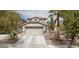 Charming two-story home featuring a two-car garage and landscaped front yard, creating a welcoming curb appeal at 3128 Spring City Ave, North Las Vegas, NV 89081