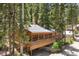 Charming exterior with wooden porch surrounded by mature trees at 4581 Aspen Ave, Mount Charleston, NV 89124