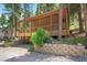 Exterior of home with elevated covered deck and retaining wall at 4581 Aspen Ave, Mount Charleston, NV 89124