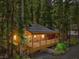 Charming cabin with a covered porch, surrounded by lush greenery and mature trees at 4581 Aspen Ave, Mount Charleston, NV 89124