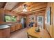 Charming kitchen featuring wood cabinets, stainless steel appliances, and a cozy dining area at 4581 Aspen Ave, Mount Charleston, NV 89124