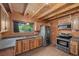Well-equipped kitchen with wood cabinets, stainless steel appliances, and a view of the outdoors at 4581 Aspen Ave, Mount Charleston, NV 89124
