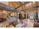 Cozy living room featuring exposed wood beams, a comfortable sofa, and ample natural light at 4581 Aspen Ave, Mount Charleston, NV 89124