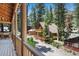 View from porch to home with two decks surrounded by tall trees at 4581 Aspen Ave, Mount Charleston, NV 89124