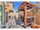 Backyard patio with pavers, a pergola, seating area and potted plants create a relaxing outdoor space at 4725 Blaise Ave # 103, North Las Vegas, NV 89084