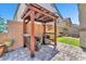 Charming patio with pavers, a pergola, seating area, artificial turf and bbq, perfect for outdoor entertaining at 4725 Blaise Ave # 103, North Las Vegas, NV 89084